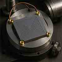 silicon radiation detector mounted in a scientific setup, featuring concentric etched patterns and thick wafer construction