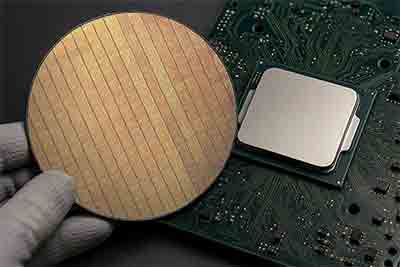 Silicon wafer with integrated circuits next to a computer processor on PCB
