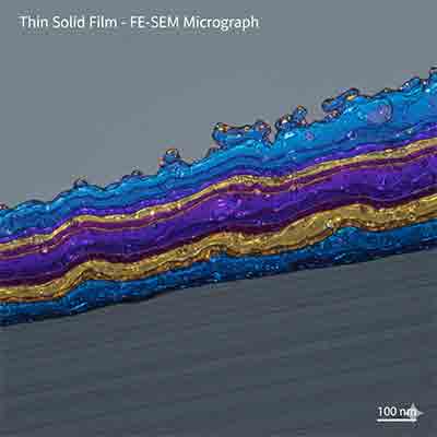 Cross-section FE-SEM micrograph showing multi-layered thin solid film deposition on a silicon substrate at 100nm scale